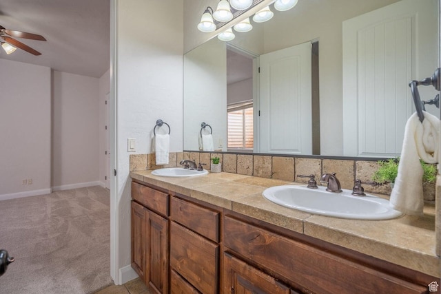 2104 S Corral Way, Washington, UT 84780 - bathroom with double vanity, baseboards, a sink, and a ceiling fan