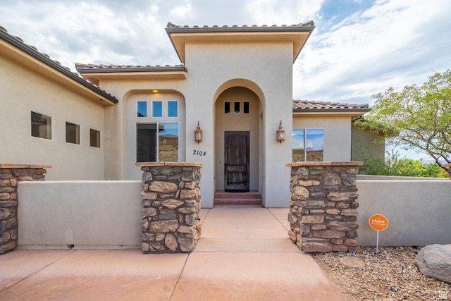 2104 S Corral Way, Washington, UT 84780 - doorway to property featuring stone siding, a tiled roof, and stucco siding