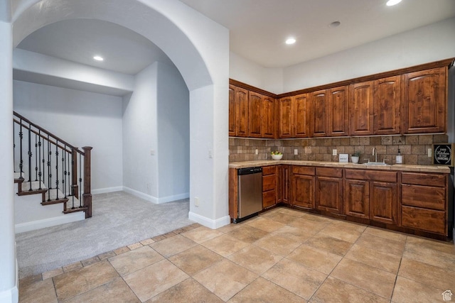 2104 S Corral Way, Washington, UT 84780 - kitchen featuring light countertops, arched walkways, stainless steel dishwasher, a sink, and backsplash