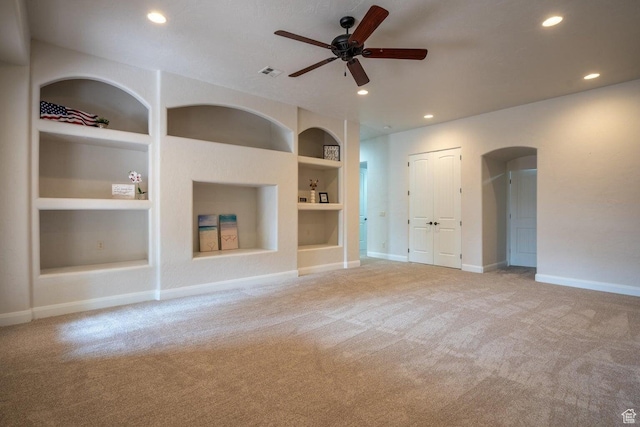 2104 S Corral Way, Washington, UT 84780 - unfurnished living room with built in features, ceiling fan, baseboards, and light carpet