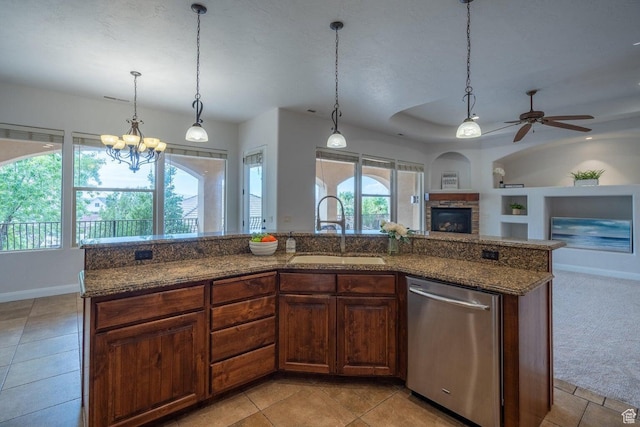 2104 S Corral Way, Washington, UT 84780 - kitchen featuring ceiling fan with notable chandelier, built in shelves, stainless steel dishwasher, a sink, and a stone fireplace
