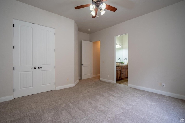 2104 S Corral Way, Washington, UT 84780 - unfurnished bedroom featuring a closet, connected bathroom, baseboards, and light colored carpet