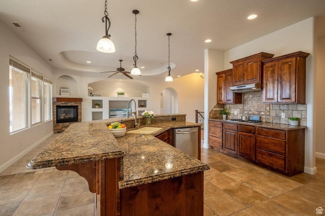 2104 S Corral Way, Washington, UT 84780 - kitchen featuring a ceiling fan, appliances with stainless steel finishes, under cabinet range hood, a sink, and backsplash