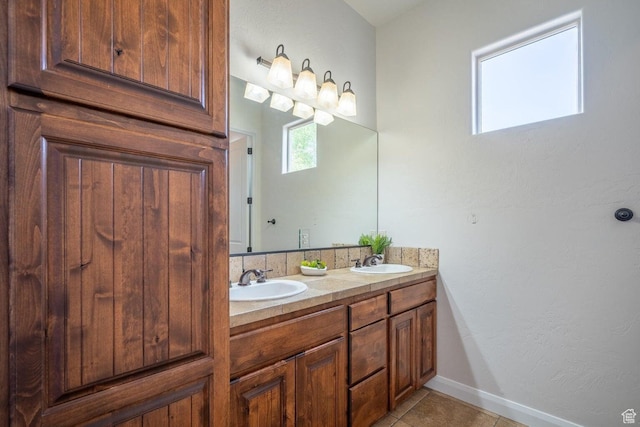2104 S Corral Way, Washington, UT 84780 - bathroom with tile patterned flooring, a sink, double vanity, and baseboards