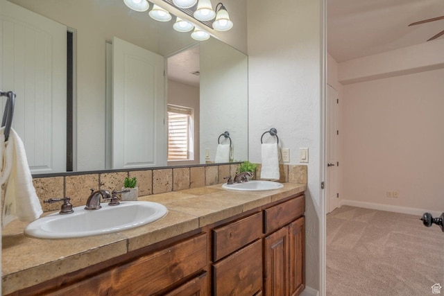 2104 S Corral Way, Washington, UT 84780 - bathroom with baseboards, double vanity, a sink, and a ceiling fan