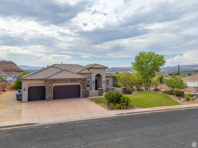2104 S Corral Way, Washington, UT 84780 - mediterranean / spanish house with a tile roof, stone siding, concrete driveway, stucco siding, and an attached garage