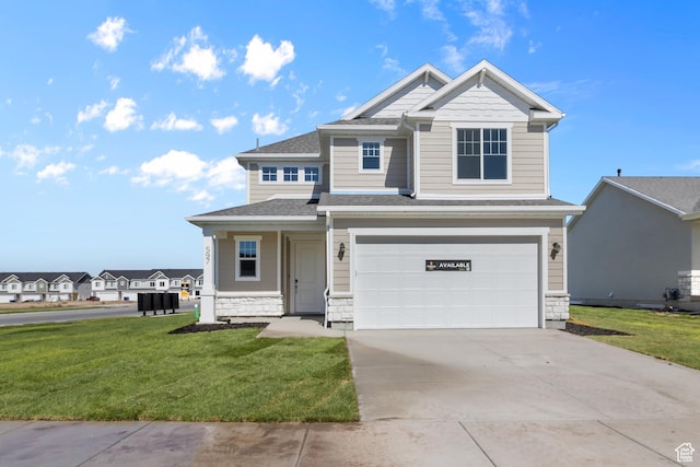 craftsman-style house with concrete driveway, an attached garage, stone siding, a front yard, and a shingled roof