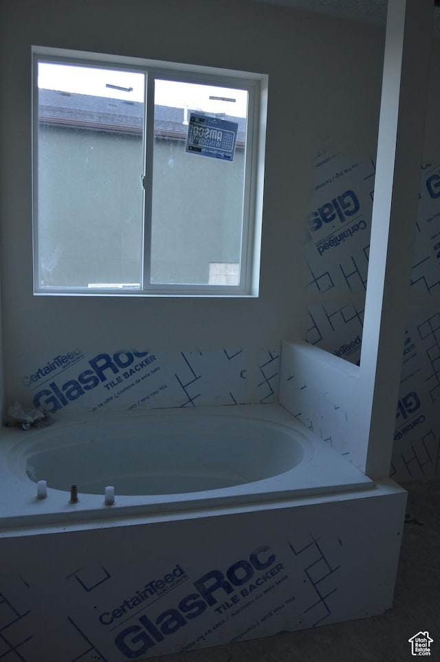 bathroom with a garden tub