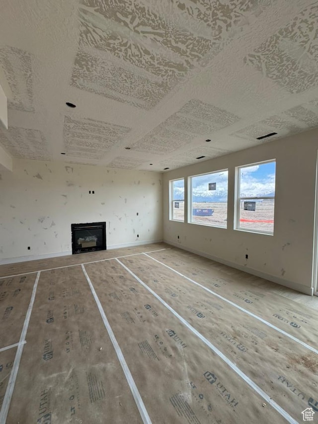 1708 S 4300th St W Unit 102, West Weber, UT 84401 - unfurnished living room featuring visible vents, baseboards, and a fireplace