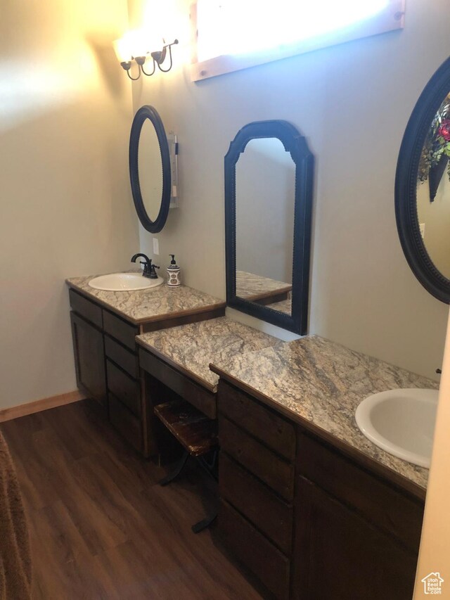 11741 E 14330 N Unit 232, Mount Pleasant, UT 84647 - bathroom featuring a sink, two vanities, baseboards, and wood finished floors