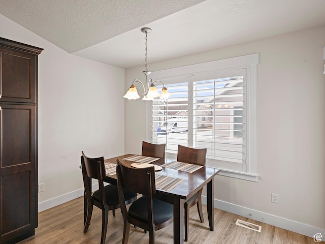 4981 W Longboat Ln, Herriman, UT 84096 - dining space with baseboards, a chandelier, and light wood finished floors