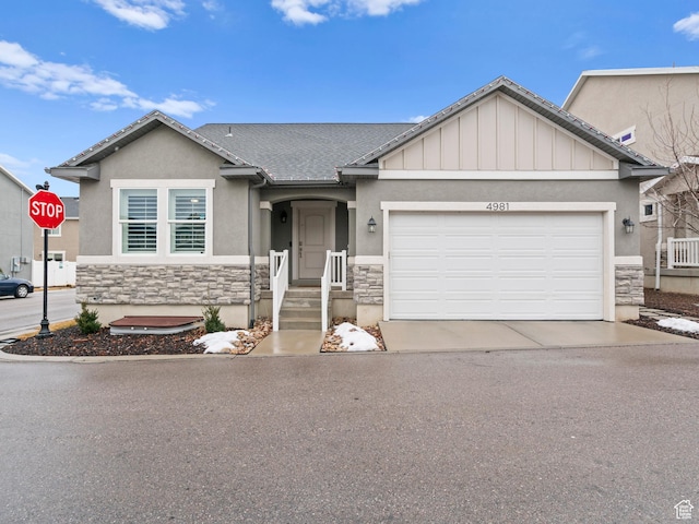 ranch-style home with stucco siding, stone siding, a garage, and concrete driveway