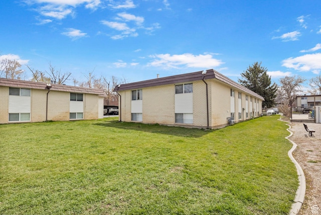 314 W Center St Unit F118, Bountiful, UT 84010 - rear view of house with a yard and brick siding