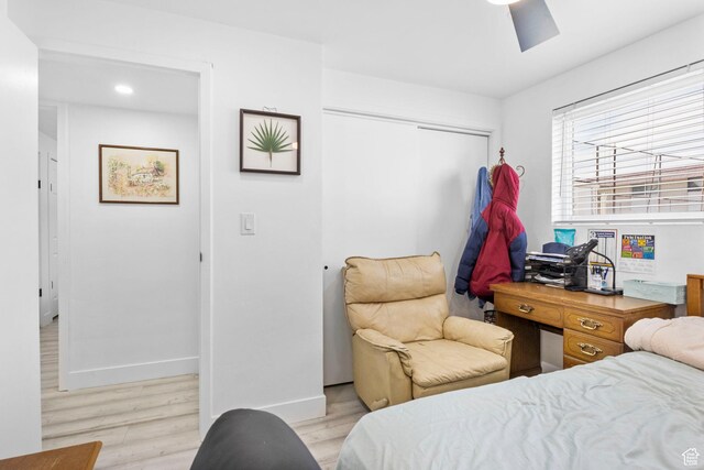 314 W Center St Unit F118, Bountiful, UT 84010 - bedroom featuring a closet, baseboards, a ceiling fan, light wood-type flooring, and a skylight