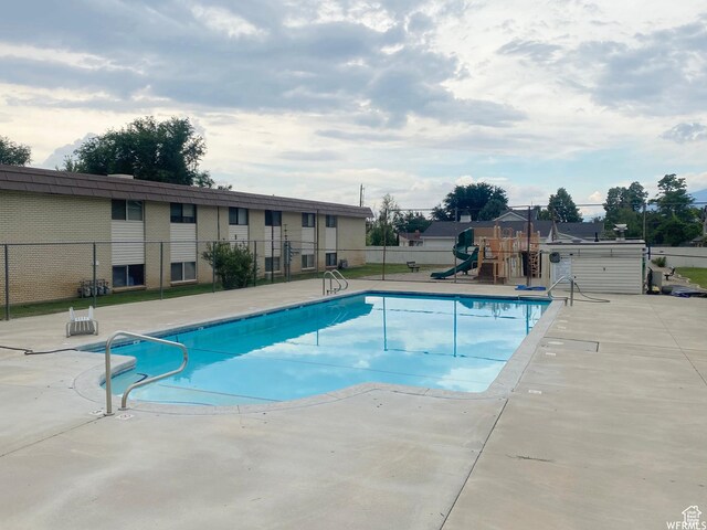 314 W Center St Unit F118, Bountiful, UT 84010 - pool featuring a patio, fence, and playground community