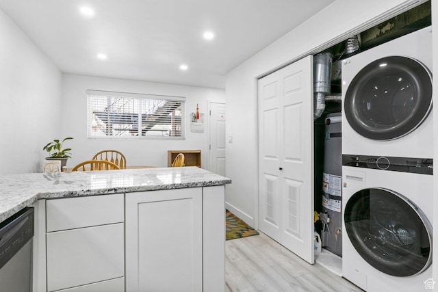 314 W Center St Unit F118, Bountiful, UT 84010 - laundry area with recessed lighting, stacked washing maching and dryer, light wood finished floors, and laundry area