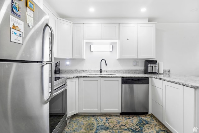 314 W Center St Unit F118, Bountiful, UT 84010 - kitchen with stainless steel appliances, a peninsula, white cabinetry, and a sink