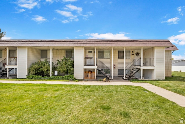 314 W Center St Unit F118, Bountiful, UT 84010 - single story home with stairway, a porch, brick siding, and a front lawn