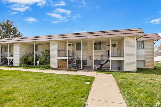 314 W Center St Unit F118, Bountiful, UT 84010 - view of front of home featuring a porch, mansard roof, a front lawn, and stairs