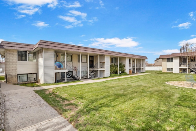 314 W Center St Unit F118, Bountiful, UT 84010 - back of property with a yard, brick siding, covered porch, and stairs
