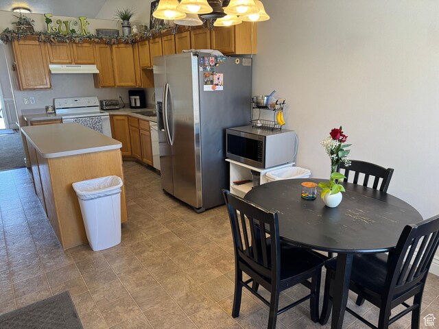 4625 W Harvey Blvd, Cedar Hills, UT 84062 - kitchen with light countertops, pendant lighting, appliances with stainless steel finishes, a center island, and under cabinet range hood