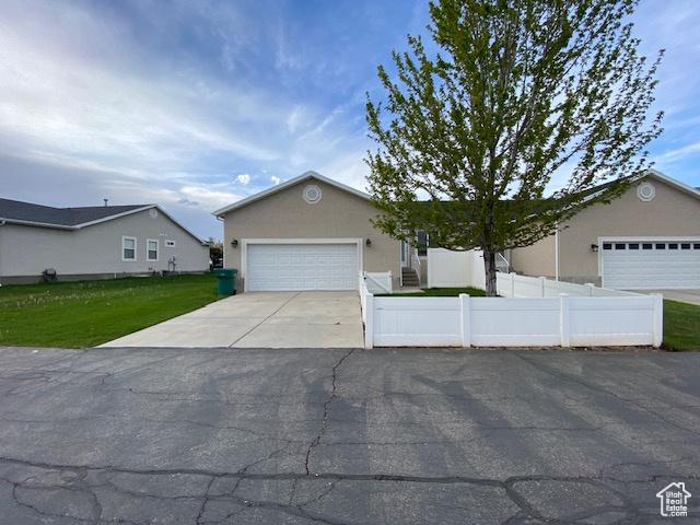 4625 W Harvey Blvd, Cedar Hills, UT 84062 - ranch-style home with driveway, a fenced front yard, an attached garage, and stucco siding