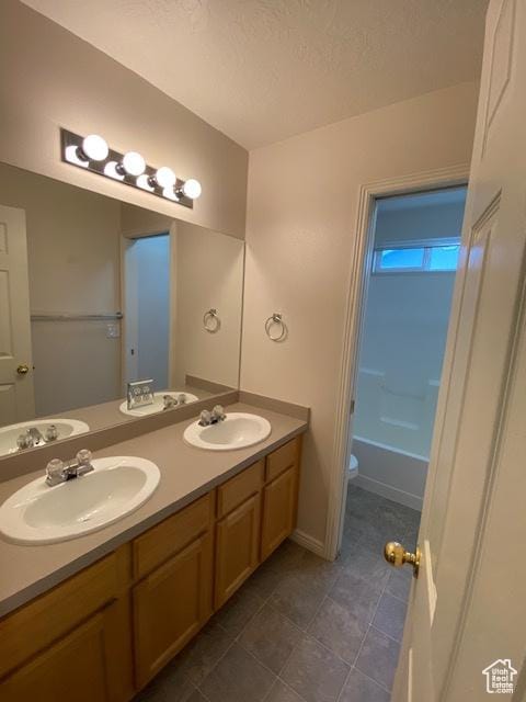 4625 W Harvey Blvd, Cedar Hills, UT 84062 - full bathroom featuring double vanity, a sink, tile patterned floors, and a bath