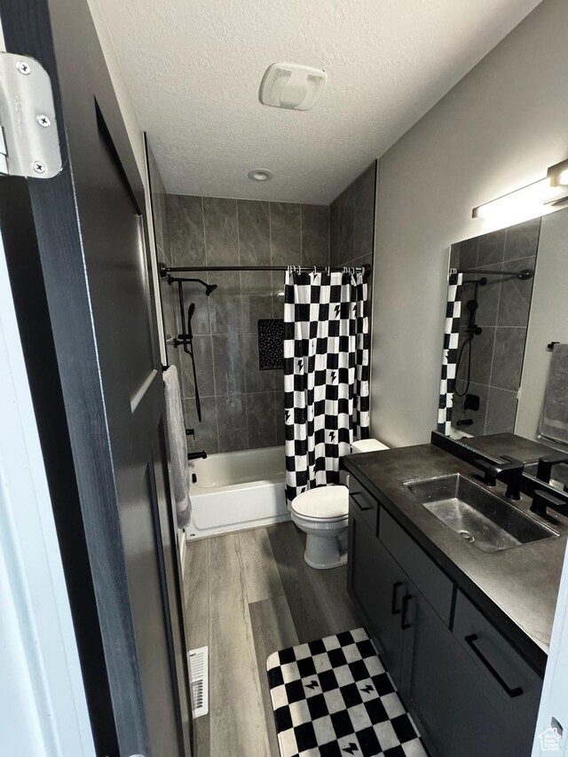 340 E 300 N, Moroni, UT 84646 - full bathroom featuring wood finished floors, vanity, a textured ceiling, shower / tub combo, and toilet