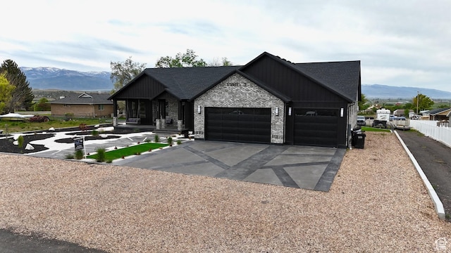 340 E 300 N, Moroni, UT 84646 - view of front of home featuring driveway, a garage, a mountain view, and brick siding