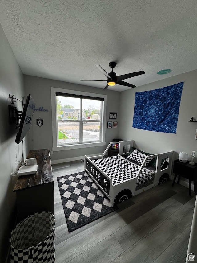 340 E 300 N, Moroni, UT 84646 - bedroom featuring wood finished floors, a textured ceiling, ceiling fan, and baseboards