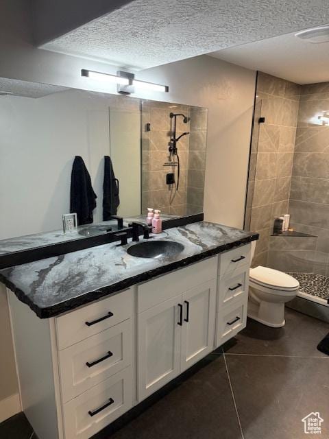 340 E 300 N, Moroni, UT 84646 - full bath featuring tile patterned flooring, vanity, a tile shower, toilet, and a textured ceiling