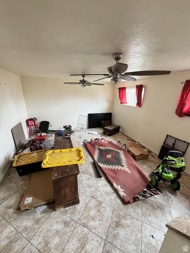 627 E Valley View Dr, Tooele, UT 84074 - living room with a textured ceiling, ceiling fan, baseboards, and tile patterned flooring