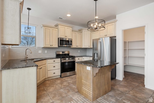 954 N Ocotillo Dr, Washington, UT 84780 - kitchen featuring visible vents, appliances with stainless steel finishes, a sink, cream cabinets, and backsplash