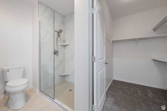 954 N Ocotillo Dr, Washington, UT 84780 - bathroom featuring baseboards, toilet, tile patterned floors, tiled shower, and a walk in closet
