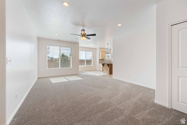 954 N Ocotillo Dr, Washington, UT 84780 - unfurnished living room with light carpet, baseboards, ceiling fan, and recessed lighting
