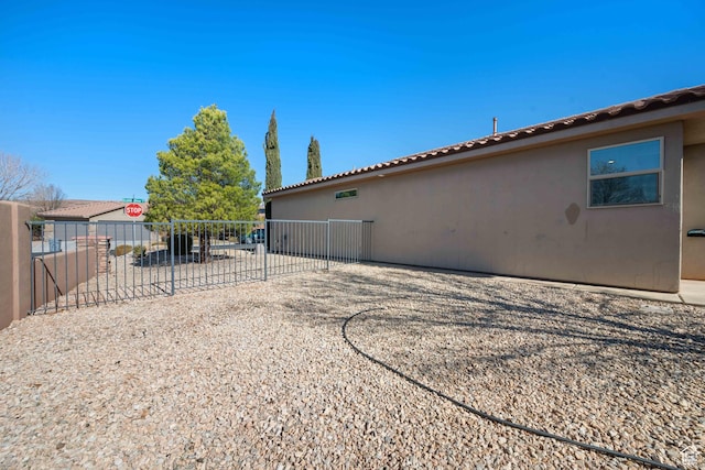 954 N Ocotillo Dr, Washington, UT 84780 - exterior space featuring a tiled roof, stucco siding, and fence
