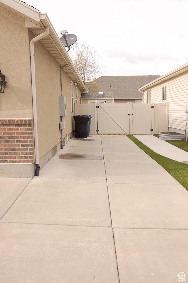 1751 E 1130 S, Spanish Fork, UT 84660 - view of home's exterior with a gate, stucco siding, and a patio