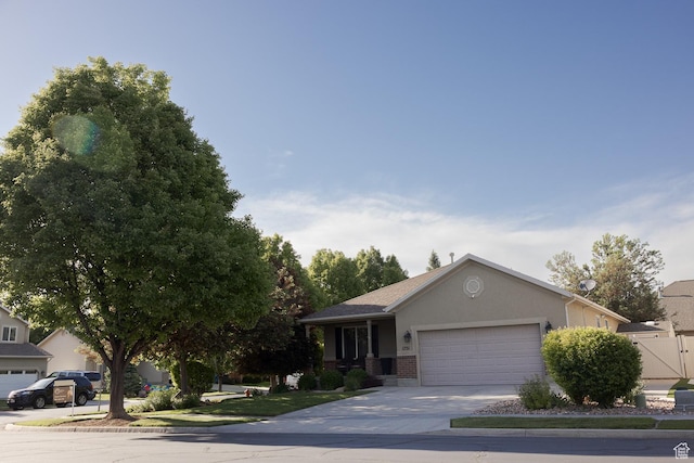 1751 E 1130 S, Spanish Fork, UT 84660 - view of front of house featuring a garage, concrete driveway, brick siding, and stucco siding