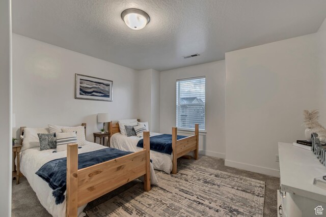 138 N Valcrest Dr, Saratoga Springs, UT 84045 - carpeted bedroom with baseboards, a textured ceiling, and visible vents