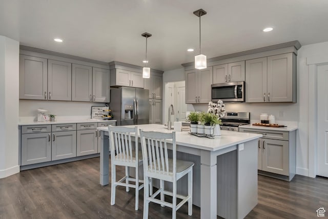 138 N Valcrest Dr, Saratoga Springs, UT 84045 - kitchen with a kitchen breakfast bar, gray cabinets, dark wood-style flooring, and stainless steel appliances
