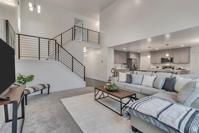 138 N Valcrest Dr, Saratoga Springs, UT 84045 - carpeted living area featuring a high ceiling, baseboards, stairway, and recessed lighting