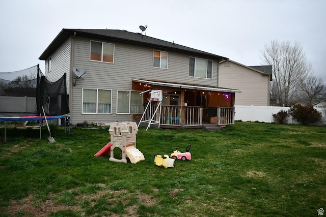 148 N Walton Ct W, North Salt Lake, UT 84054 - rear view of house with fence, a trampoline, and a yard