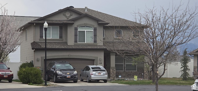 148 N Walton Ct W, North Salt Lake, UT 84054 - view of front facade with stucco siding, an attached garage, a shingled roof, and concrete driveway