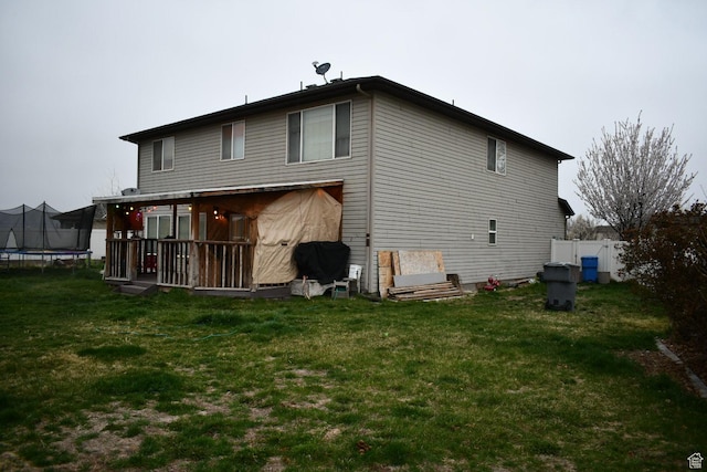 148 N Walton Ct W, North Salt Lake, UT 84054 - back of house featuring fence, a trampoline, and a yard