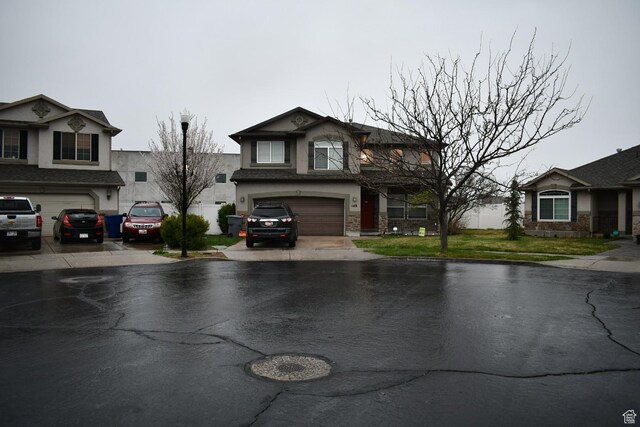 148 N Walton Ct W, North Salt Lake, UT 84054 - view of front facade featuring stucco siding, an attached garage, and aphalt driveway
