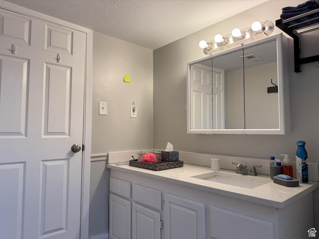 95 E Continental Dr S Unit 61-G, Farmington, UT 84025 - bathroom with vanity, visible vents, and a textured ceiling