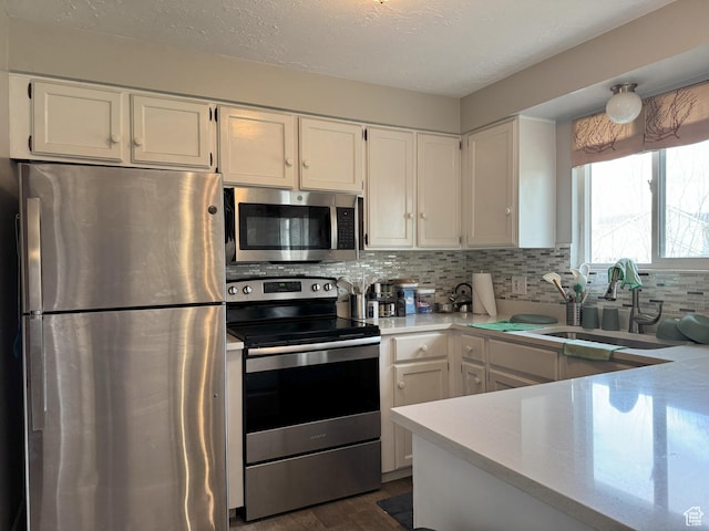 95 E Continental Dr S Unit 61-G, Farmington, UT 84025 - kitchen featuring light countertops, a sink, stainless steel appliances, and white cabinets
