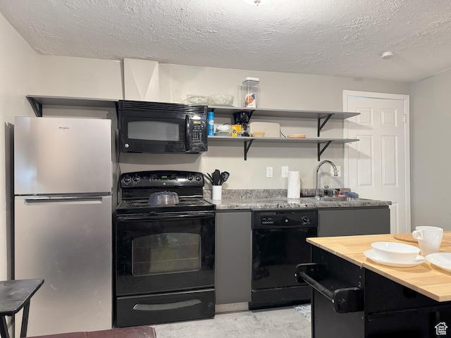 95 E Continental Dr S Unit 61-G, Farmington, UT 84025 - kitchen featuring wood counters, dark cabinets, black appliances, and a textured ceiling