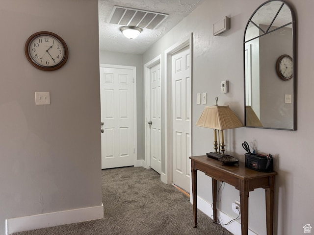 95 E Continental Dr S Unit 61-G, Farmington, UT 84025 - corridor with carpet flooring, a textured ceiling, baseboards, and visible vents