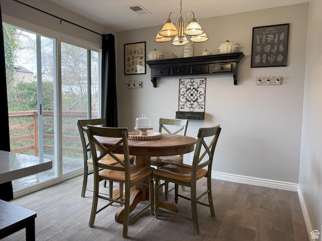 95 E Continental Dr S Unit 61-G, Farmington, UT 84025 - dining room featuring light wood finished floors, baseboards, visible vents, and a chandelier